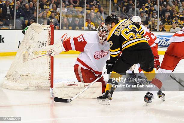 Brad Marchand of the Boston Bruins fights for the puck against the Detroit Red Wings in Game Five of the First Round of the 2014 Stanley Cup Playoffs...