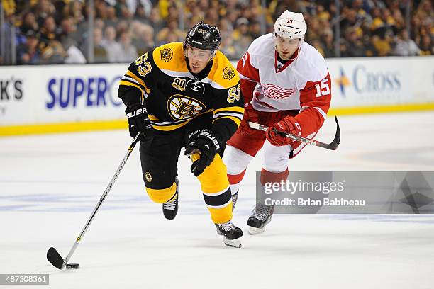 Brad Marchand of the Boston Bruins skates with the puck against Riley Sheahan of the Detroit Red Wings in Game Five of the First Round of the 2014...