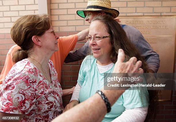 Kim Davis, center, and husband Joe Davis are greeted by relatives, including Kim's mother Jean Bailey, left, outside the Carter County Detention...