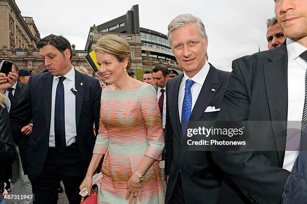 King Philippe and Queen Mathilde of Belgium take a short walk to Rosenbad during their visit to Sweden on April 29, 2014 in Stockholm, Sweden.