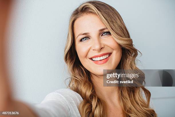 beautiful mid-age woman. - blonde woman selfie stock pictures, royalty-free photos & images