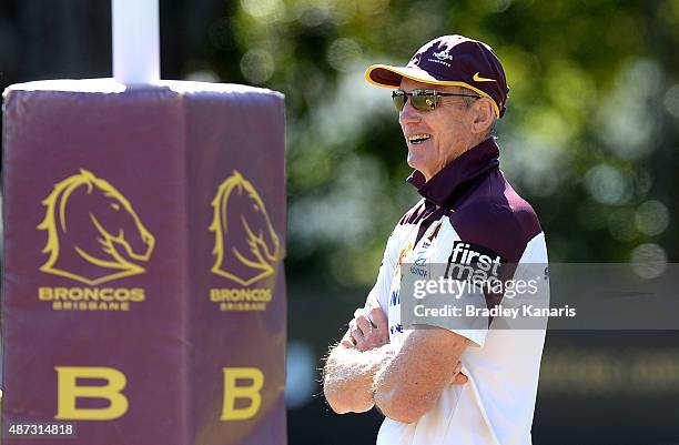 Coach Wayne Bennett smiles as he watches on during a Brisbane Broncos NRL training session on September 9, 2015 in Brisbane, Australia.