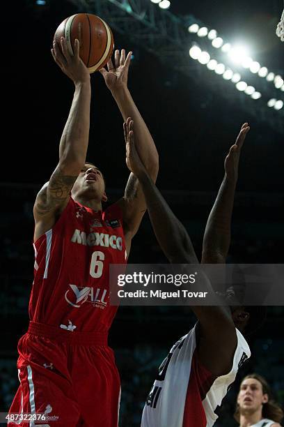 Juan Toscano of Mexico shoots to the basket as Anthony Bennett of Canada defends during a second stage match between Mexico and Canada as part of the...