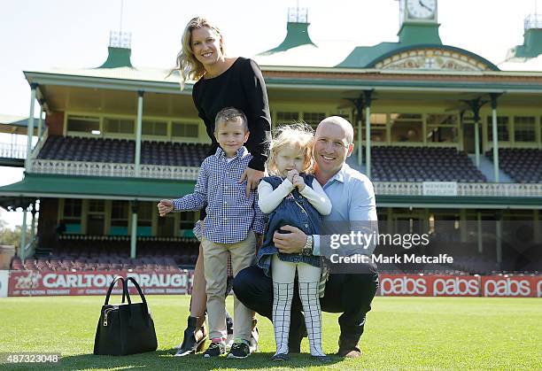 Brad Haddin holds his daughter Mia as poses on the field with his Wife Karina and son Zac after announcing his retirement from cricket during a press...