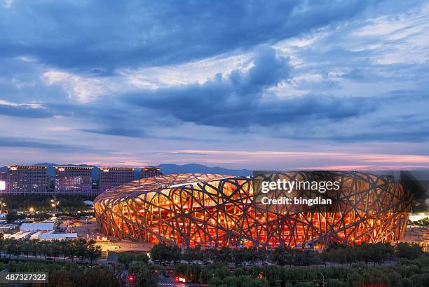 the beijing national stadium at night - birds nest stock pictures, royalty-free photos & images