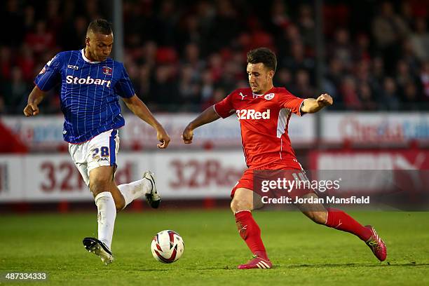 Matt Tubbs of Crawley Town takes the ball past Reece Brown of Carlisle United during the Sky Bet League One match between Crawley Town and Carlisle...