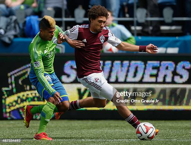 DeAndre Yedlin of the Seattle Sounders FC battles Chris Klute of the Colorado Rapids at CenturyLink Field on April 26, 2014 in Seattle, Washington....