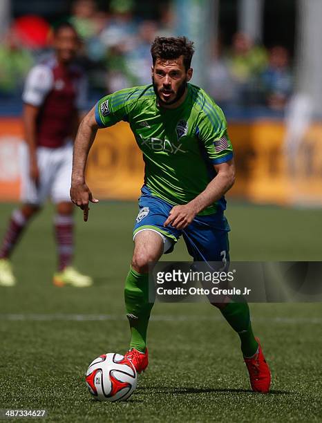 Brad Evans of the Seattle Sounders FC dribbles against the Colorado Rapids at CenturyLink Field on April 26, 2014 in Seattle, Washington. The...