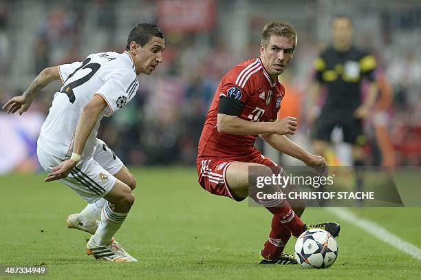 Real Madrid's Argentinian midfielder Angel di Maria and Bayern Munich's defender Philipp Lahm vie during the UEFA Champions League second-leg...