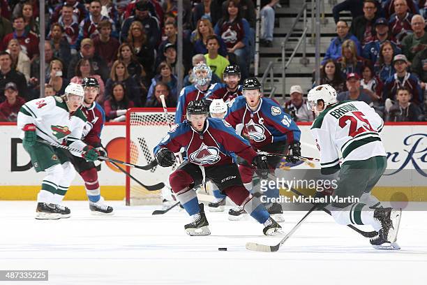 Nathan MacKinnon of the Colorado Avalanche skates into position to defend against Jonas Brodin of the Minnesota Wild in Game Five of the First Round...
