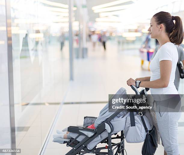 girl walking baby in baby carriage - sports clothing retail stock pictures, royalty-free photos & images