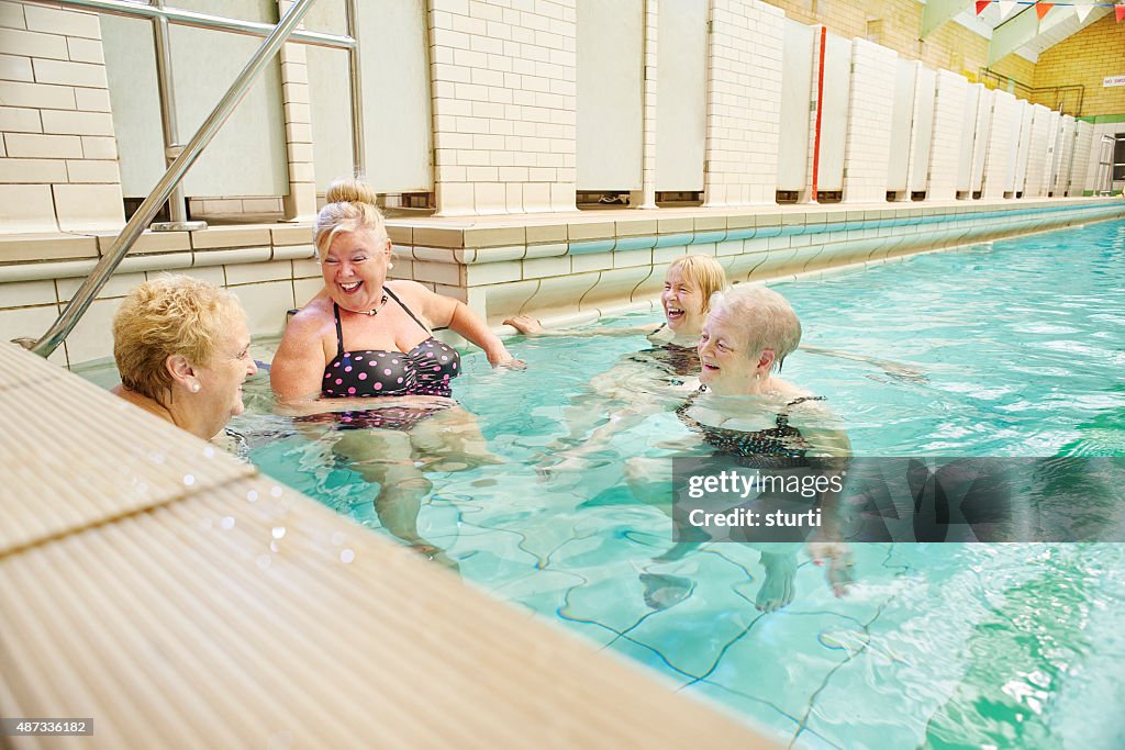 Senior ladies gossip in pool