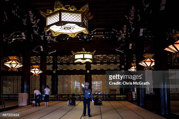 Security guard tells tourists to not take photographs inside the Higashi-Honganji Temple on September 5, 2015 in Kyoto, Japan. The famous city of...