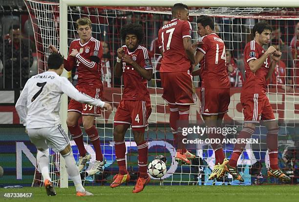 Real Madrid's Portuguese forward Cristiano Ronaldo scores at the end of the UEFA Champions League second-leg semi-final football match FC Bayern...