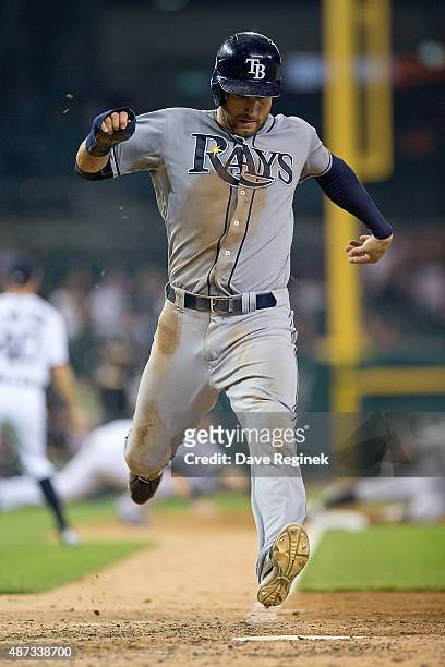 Kevin Kiermaier of the Tampa Bay Rays scores in the top of the ninth inning to tie the score 7-7 and push the game to extra innings during a MLB game...