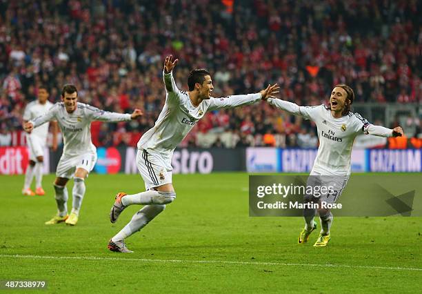 Cristiano Ronaldo of Real Madrid celebrates with Luka Modric and Gareth Bale as he scores their fourth goal during the UEFA Champions League...
