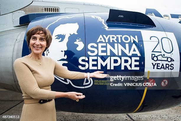 The sister of Brazilian motor racing legend Ayrton Senna, Vivian, stands next to an aircraft of Azul Brazilian airlines displaying the colours used...