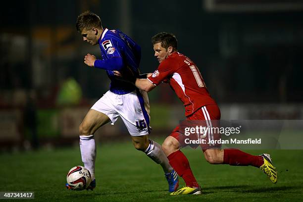 Brad Potts of Carlisle United takes the ball past Dannie Bullman of Crawley Town during the Sky Bet League One match between Crawley Town and...