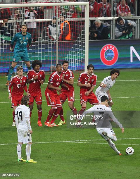 Cristiano Ronaldo of Real Madrid takes a free kick and scores the team's fourth goal during the UEFA Champions League semi final second leg match...