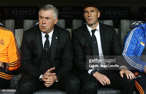 Coach of Real Madrid Carlo Ancelotti and his assistant Zinedine Zidane attend on the bench during the UEFA Champions League semi-final second leg...