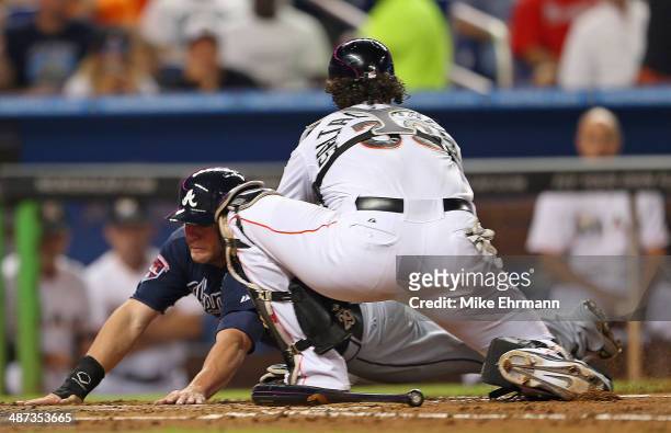 Tyler Pastornicky of the Atlanta Braves is tagged out at home by Jarrod Saltalamacchia of the Miami Marlins during a game at Marlins Park on April...