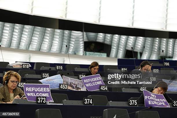 Members of the left wings listens to the European Commission's President Jean-Claude Juncker in the plenary room of the European Parliament and hold...