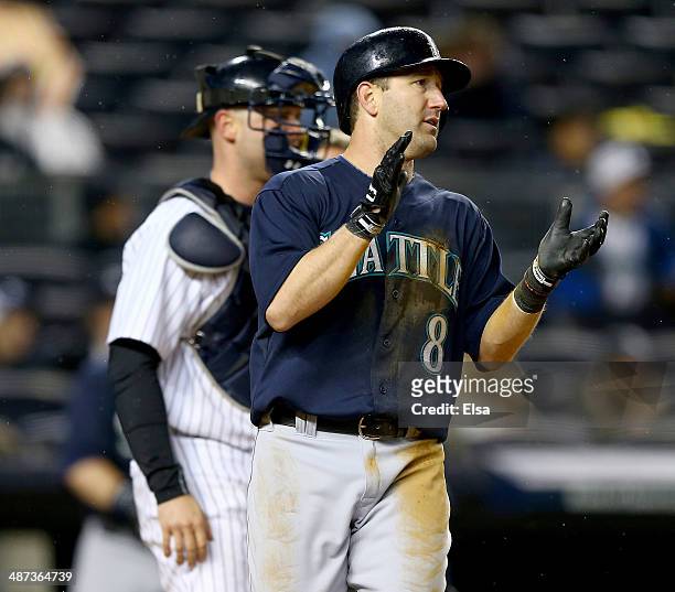 Willie Bloomquist of the Seattle Mariners celebrates after he scored on a double by Corey Hart in the fifth inning against the New York Yankees on...