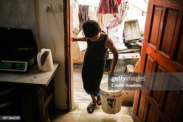 Boy carries a water bucket in Gaza City, Gaza on September 9, 2015. At least 120,000 Palestinians face water crisis just because infrastructure...