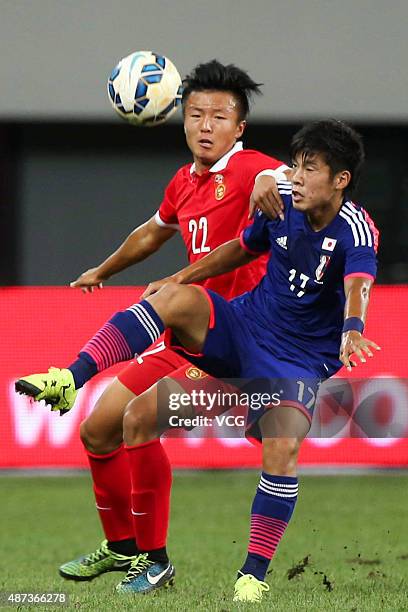 Takagi Akito of Japan vies with Zhao Jianfei of China during a match between China and Japan of 2015 "Changan Ford Cup" CFA International Youth...