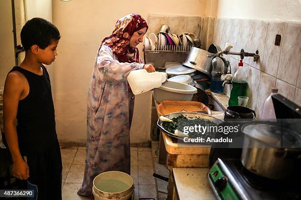 Woman uses water that her son brought with a bucket in Gaza City, Gaza on September 9, 2015. At least 120,000 Palestinians face water crisis just...