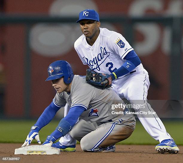 Kansas City Royals shortstop Alcides Escobar couldn't get the ball out of his glove after forcing out the Toronto Blue Jays' Brett Lawrie at second...