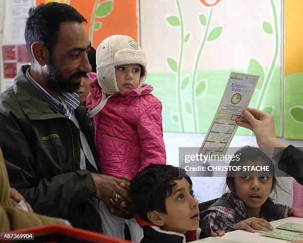 Refugee family from Syria is pictured at clothing room of "Bayernkaserne", where donations for refugess have been collected, in Munich, southern...