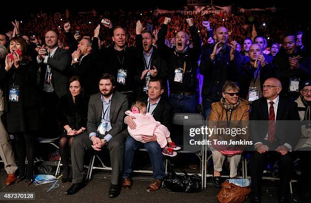 Frampton's daughter Carla sleeps through the fight held by her grandfather during the Carl Frampton v Kiko Martinez IBF world super-bantamweight...