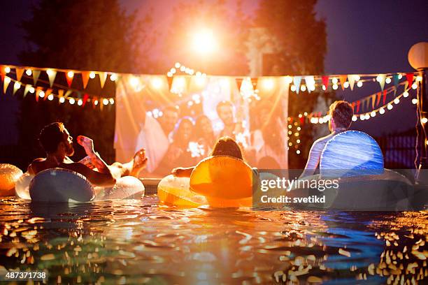 pool movie night party. - pool party night stock pictures, royalty-free photos & images