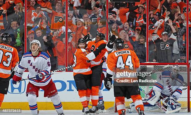 Wayne Simmonds of the Philadelphia Flyers celebrates his third goal of the game against Henrik Lundqvist of the New York Rangers with teammates Jakub...