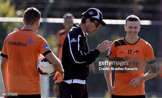 Coach Mike Mulvey shares a laugh with Matthew McKay during a Brisbane Roar A-League training session at Ballymore Stadium on April 30, 2014 in...