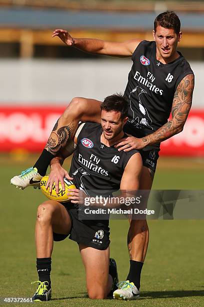 Jesse White hops on Nathan Brown during a Collingwood Magpies AFL training session at the Westpac Centre on April 30, 2014 in Melbourne, Australia.