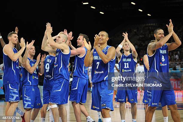 Finland's players Tuukka Kotti, Ville Kaunisto, Shawn Huff, Petteri Koponen and Gerald Lee celebrate after winning their Group A qualification...