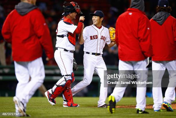 Koji Uehara of the Boston Red Sox celebrates with teammate A.J. Pierzynski following their win against the Tampa Bay Rays in the 9th inning during...