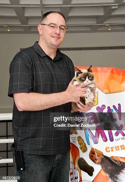 Grumpy Cat and Bryan Bundesen attend Grumpy Cat's "Grumpiest" Birthday Bash at 404 10th Avenue on April 29, 2014 in New York City.