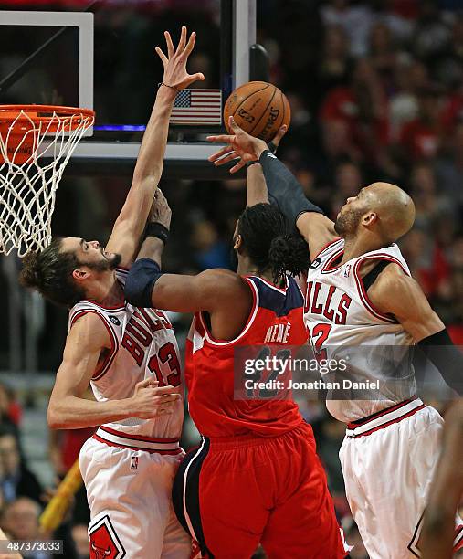 Nene of the Washington Wizards puts up a successful shot between Joakim Noah and Taj Gibson of the Chicago Bulls in Game Five of the Eastern...