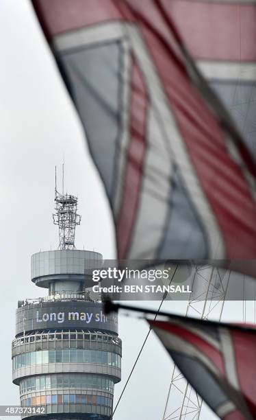 Union Flag flies in front of the BT Tower displaying the words ' Long may she reign' to pay tribute to Queen Elizabeth II becoming Britain's longest...