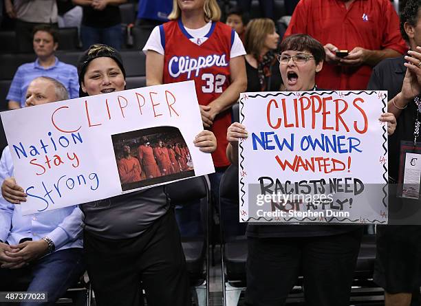 Los Angeles Clippers hold up signs referencing the Donald Sterling situation before the game with the Golden State Warriors in Game Five of the...