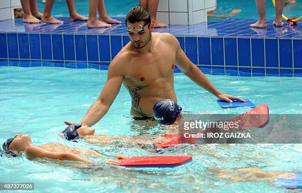 French Olympic champion Florent Manaudou stands in the water during a swimming lesson at the municipal pool on September 9 in Biarritz, southwestern...