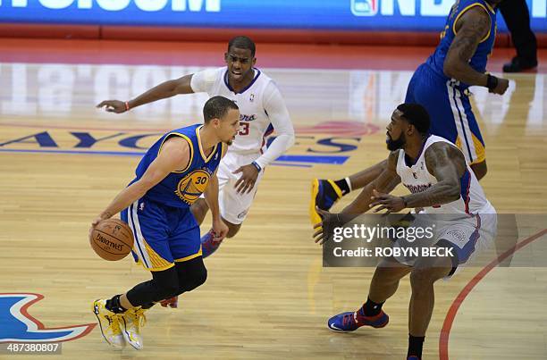 Golden States Warriors Stephen Curry drives against Los Angeles Clippers Chris Paul and DeAndre Jordan during the NBA playoff game between the Los...