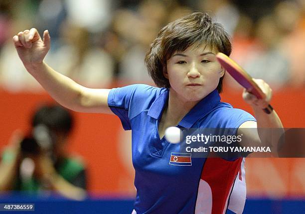 Kim Jong of North Korea returns a shot against Ding Ning of China during their women's singles round four match at the 2014 World Team Table Tennis...