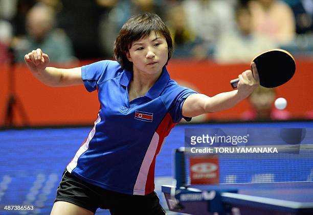 Kim Jong of North Korea returns a shot against Ding Ning of China during their women's singles round four match at the 2014 World Team Table Tennis...