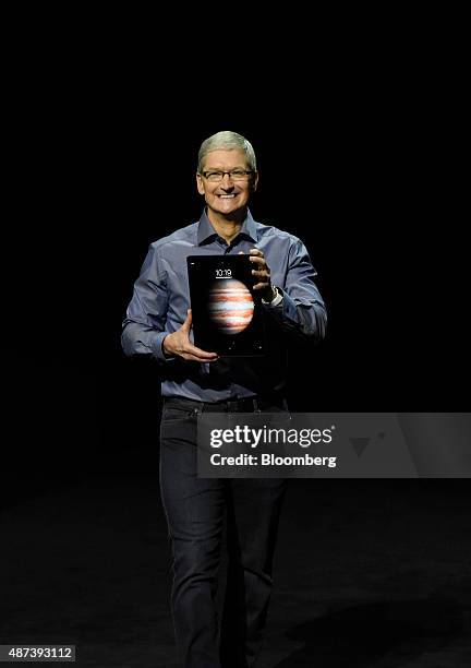Tim Cook, chief executive officer of Apple Inc., displays the new iPad Pro while speaking during an Apple product announcement in San Francisco,...