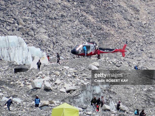 In this photograph taken on April 18 a Nepalese rescure helicopeter lands at Everest Base Camp during rescue efforts following an avalanche that...