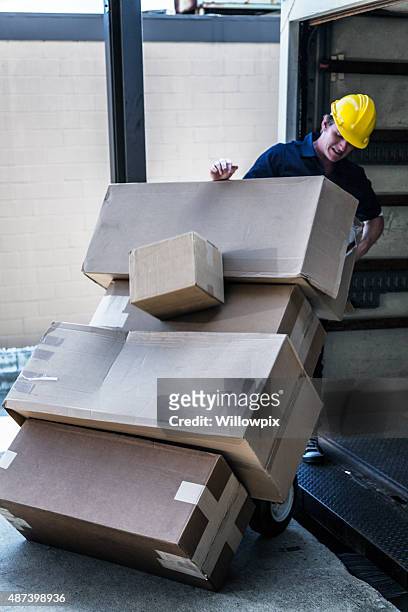 falling boxes loading dock delivery truck worker - trousers down stock pictures, royalty-free photos & images